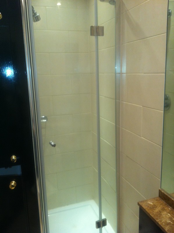 Frameless glass shower enclosure with chrome fittings in Earl's Court