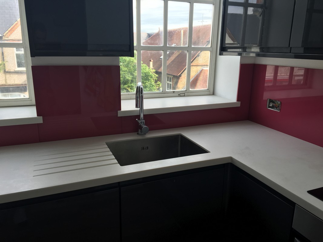 Deep plum coloured glass splashback in modern Earl's Court kitchen