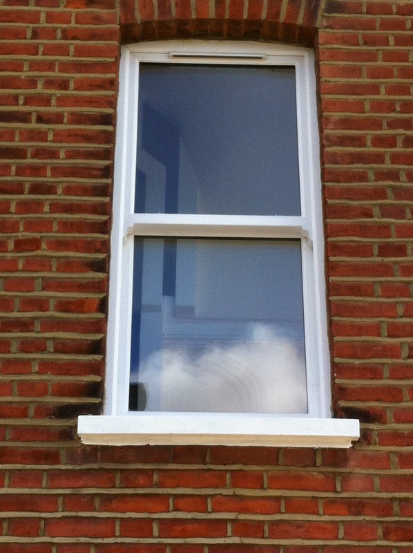 uPVC sash window on Victorian red brick house in Earl's Court